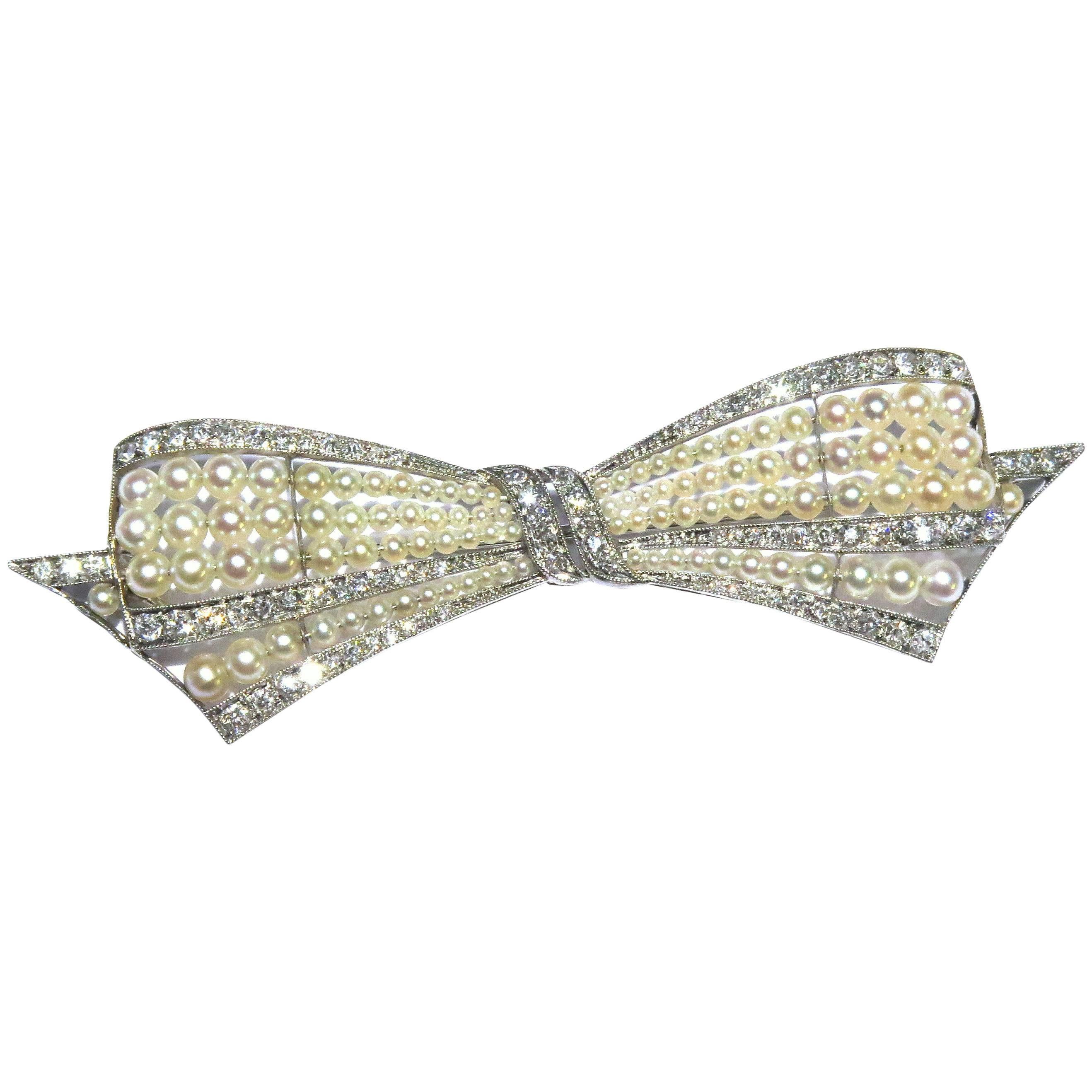 Exquisite Art Deco Natural Pearl Diamond Platinum Bow Pin For Sale