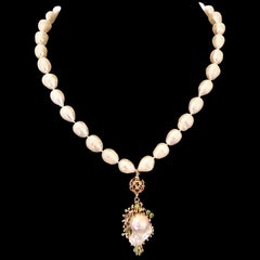 A long freshwater baroque pearl necklace with a  large freshwater pearl pendant