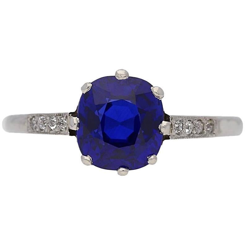 Royal Blue Kashmir sapphire and diamond ring. Centrally set with a cushion shape old cut natural unenhanced Royal Blue Kashmir sapphire in an open back claw setting with an approximate weight of 2.38 carats, flanked by eight round old cut diamonds