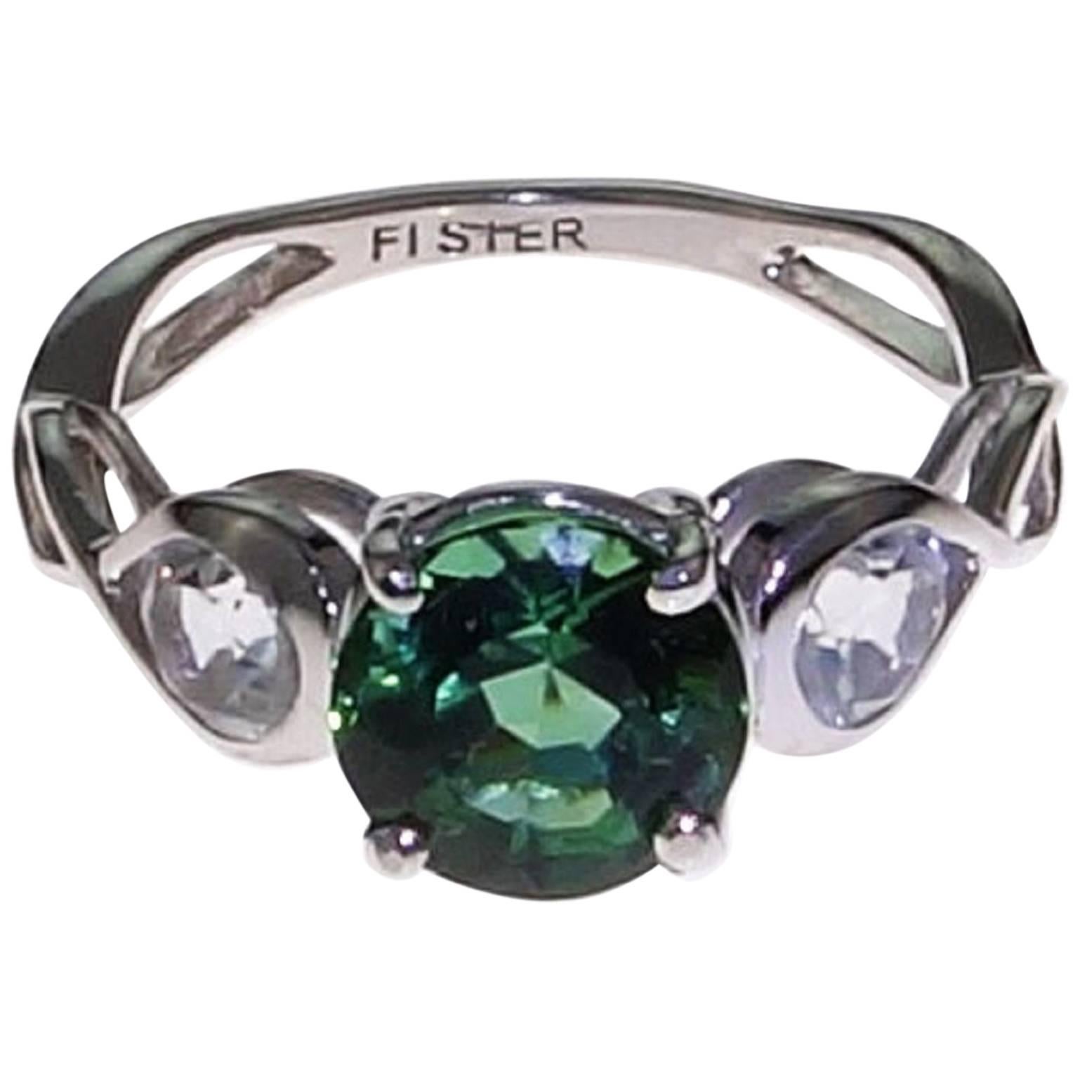 Custom made Sterling Silver ring with Flashing Round Greenish Blue Brazilian Tourmaline of 2 carats. This Gemjunky unique ring features two accent Silver Topaz gemstones of 0.80 carats. This gorgeous lively Tourmaline is straight from Minas Gerais,