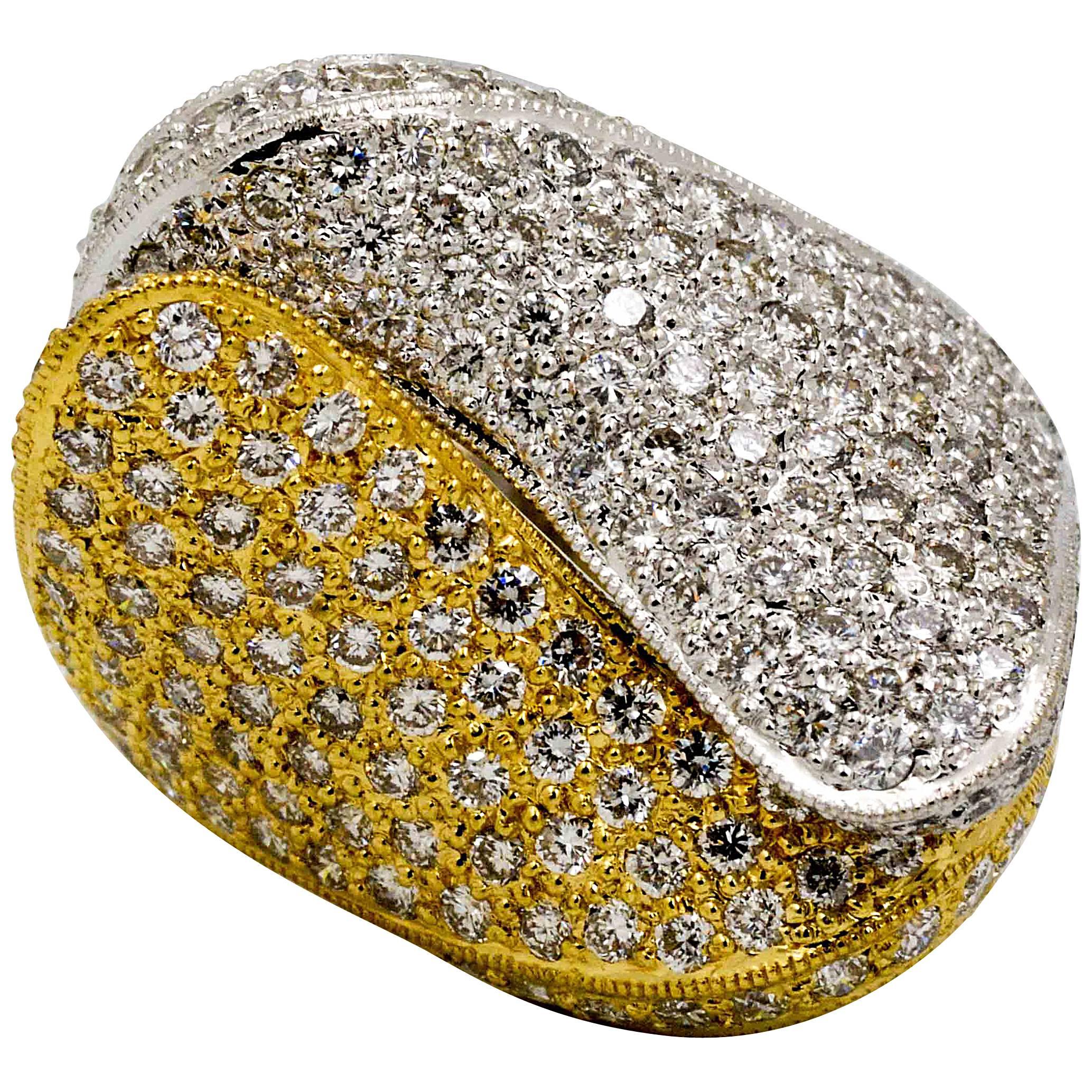 This incredibly amazing two color diamond fashion ring is crafted in an elegant paisley design which contrasts the rich 18 karat white gold against the 18 karat yellow gold.  Each half of the ring is pave' set with 134 round brilliant cut diamonds