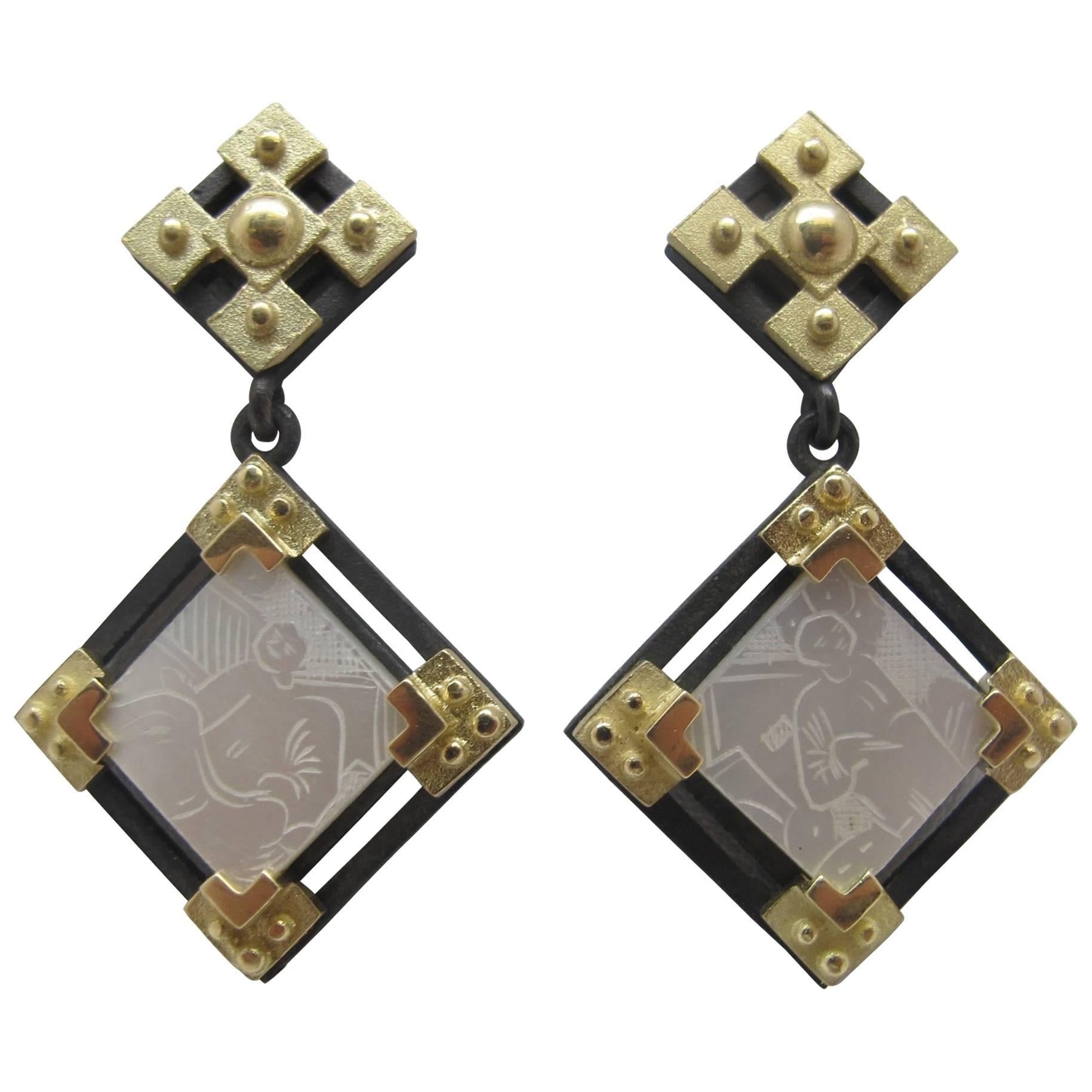 These earrings feature antique, mother-of-pearl Chinese gambling counters with motifs dating back to the 18th Century. They are original pieces that we have made in to jewelry. Originally carved in China for export to Britain, they were used like we