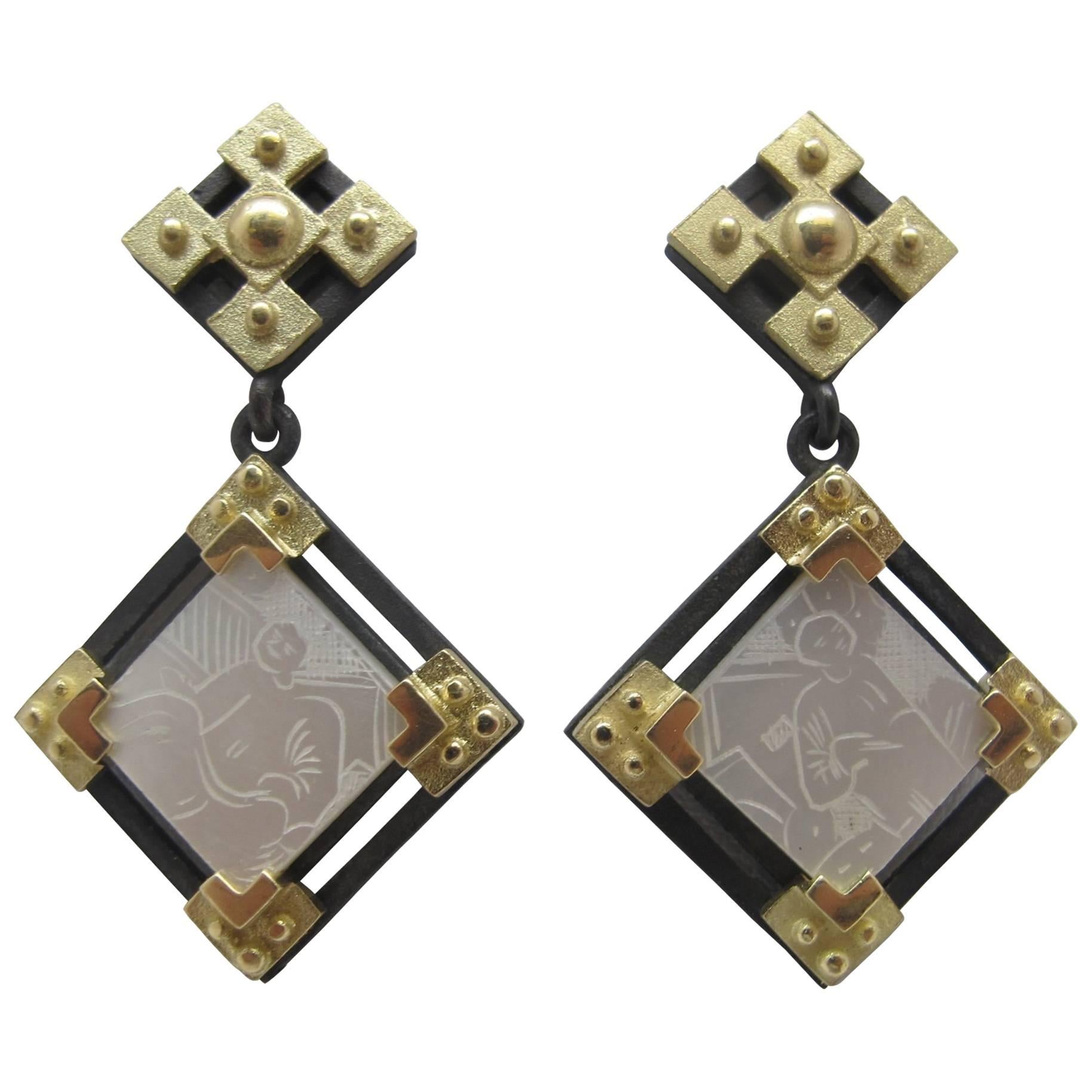 These earrings feature antique, mother-of-pearl Chinese gambling counters with motifs dating back to the 18th Century. They are original pieces that we have made in to jewelry. Originally carved in China for export to Britain, they were used like we