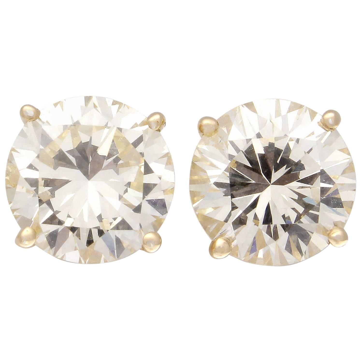 Clean, crisp elegant beauty. The earrings are scintillating and full of life. Featuring two gracefully matched modern round brilliant cut diamonds weighing 1.92 carats and 1.94 carats. Set in 18k yellow gold. Very well priced for such a big