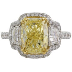 3.05 Carat GIA Certified Fancy Yellow SI2 Three-Stone Diamond Halo Ring