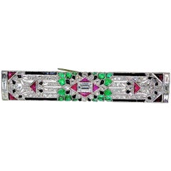 Art Deco Emerald, Diamond, Ruby and Onyx Brooch, circa 1925