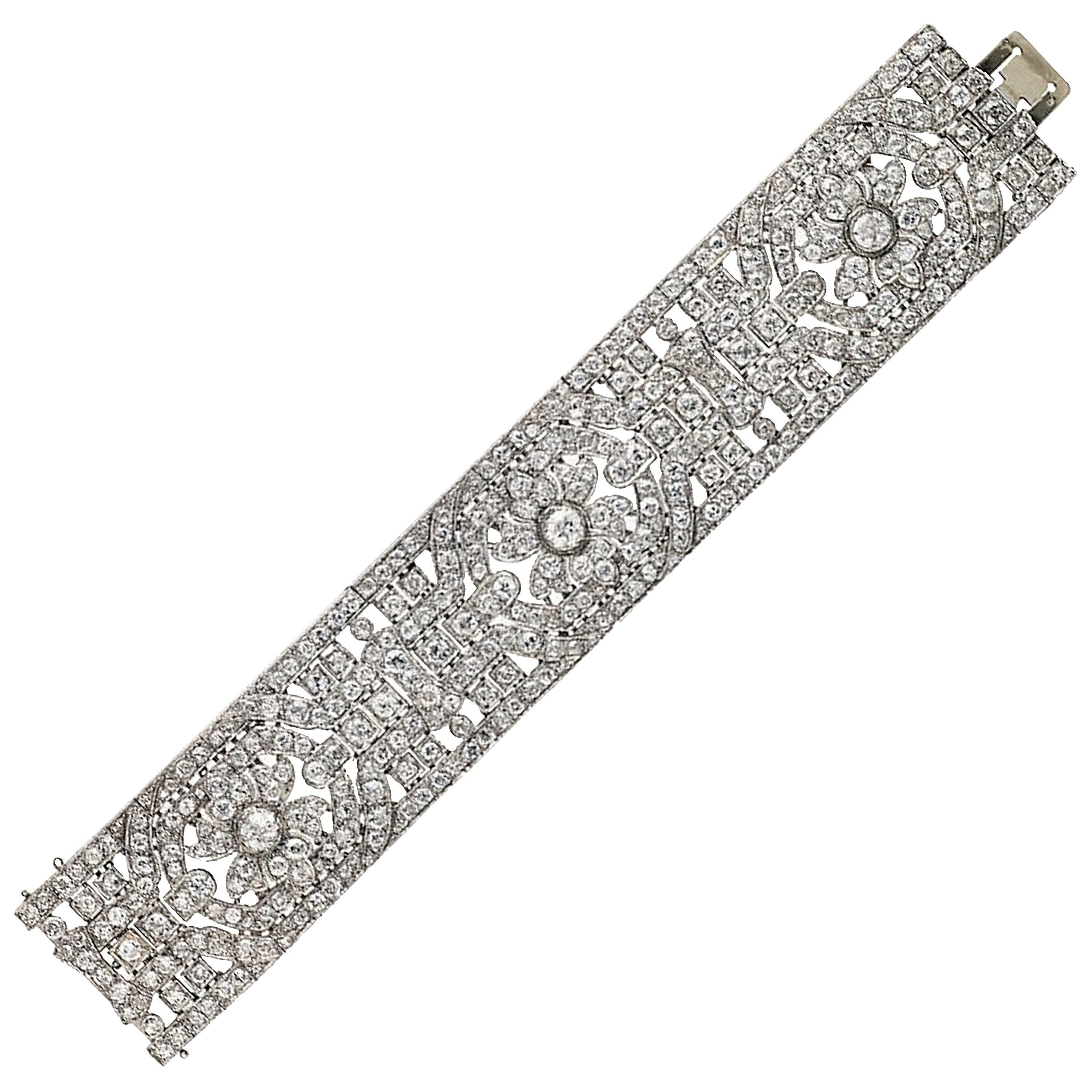 French Art Deco Diamond Platinum Bracelet.
Of openwork geometric design, centering three flowerheads, set throughout with old and single-cut diamonds. 
French assay marks for platinum and gold.
Total diamond: approximately 40.00 carats 
Length: 7.24