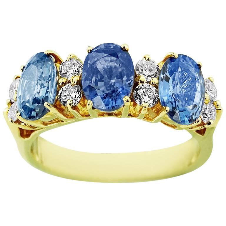 Yellow Gold Trinity with Oval Cut Sapphire and Brilliant Cut Diamonds Ring For Sale