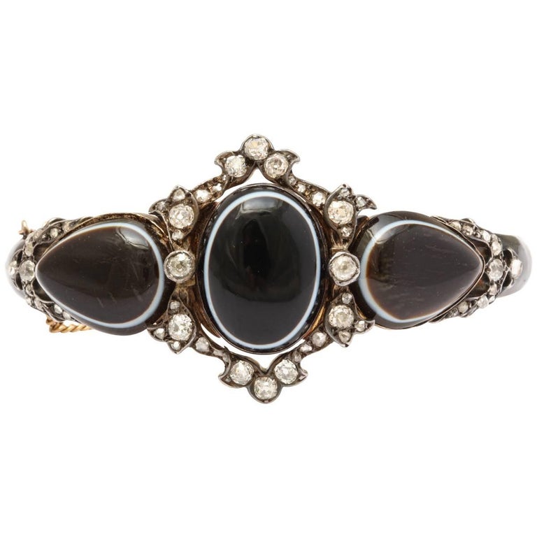 The hand of man and the wonder of nature played their parts in this shockingly stunning Victorian bracelet in black and white banded agate, two pear shaped, one large oval, all surrounded by the white of diamonds. Nature birthed the agates. Man