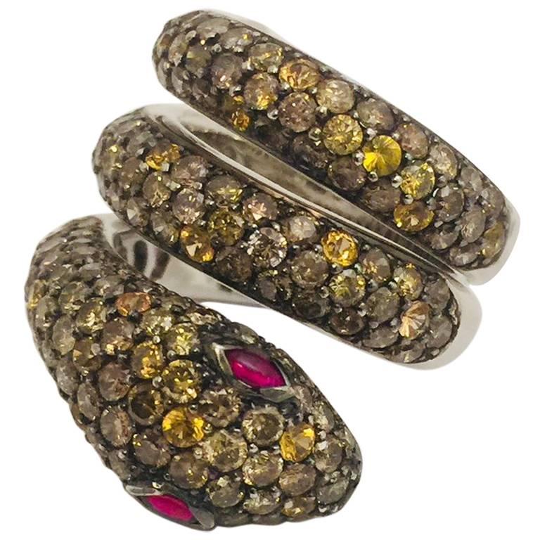 18 Karat Striking Snake Ring with Diamonds, Yellow Sapphires and Rubies For Sale
