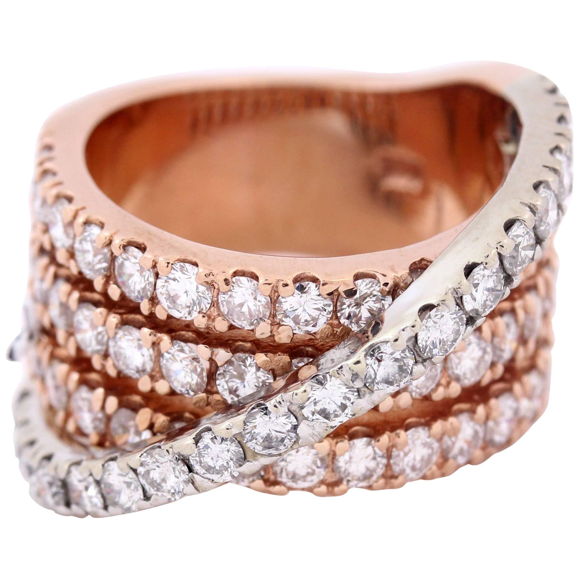 18K Rose and White Gold Band Ring with Diamonds

Diamonds are set half way on band with one layer of white gold crossing over ring. 3.20ct. apprx H Color, SI Clarity DIamonds total weight

Width is 0.5 inch.

Size 6.5. Sizable
