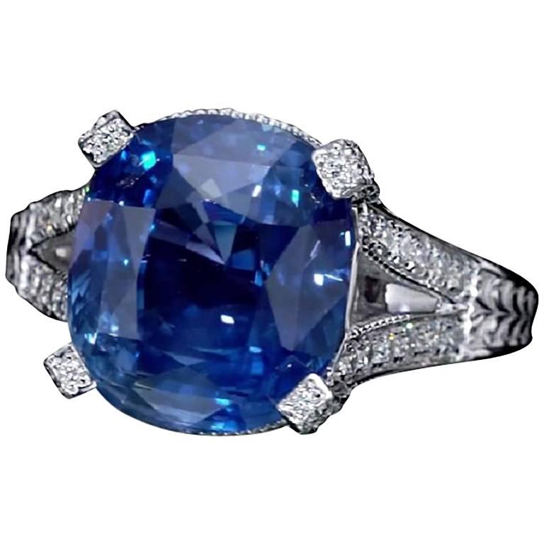 Handcrafted elegant 11.01 Carat cushion cut blue sapphire ring, GRS Certified, surrounded by 76 diamonds and mounted on 18K white gold.  
Jewel Details: 
Center-
11.01 Carat Cushion Cut Blue Sapphire, GRS certified.
Side- 
75 Round Diamonds, 0.70