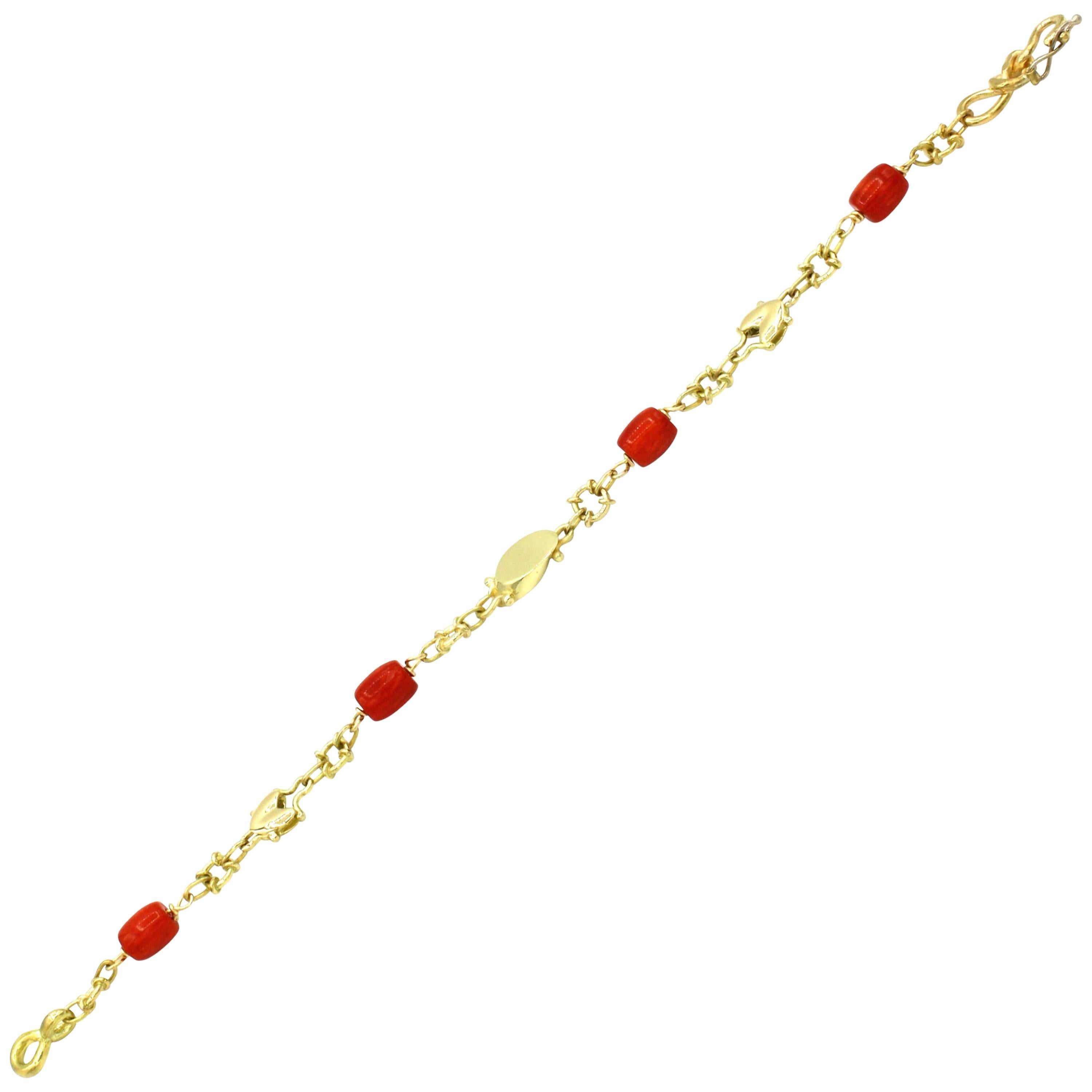 This lovely 18 kt gold bracelet has refined pieces of red coral along with a variety of elaborate links.  The style is unique with a hook and latch clasp, adding design detail to the piece.  A classic piece from Renato Cipullo's 