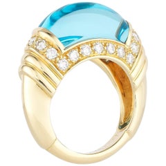 Curved Blue Topaz Yellow Gold and Diamond Ring