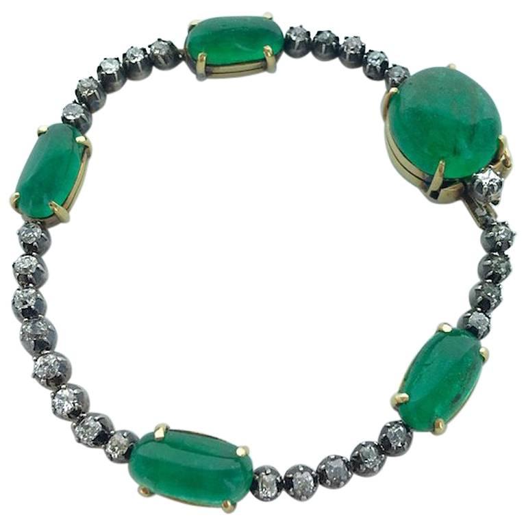 Gorgeous bracelet Old mine cut Diamond and Five cabochon Emerald including one more significant on silver and gold.
French marks.
Total Emerald weight: approximately 20.00-25.00 carat.
Total length: 7.09 inches.
Gross weight: 20.78 grams.