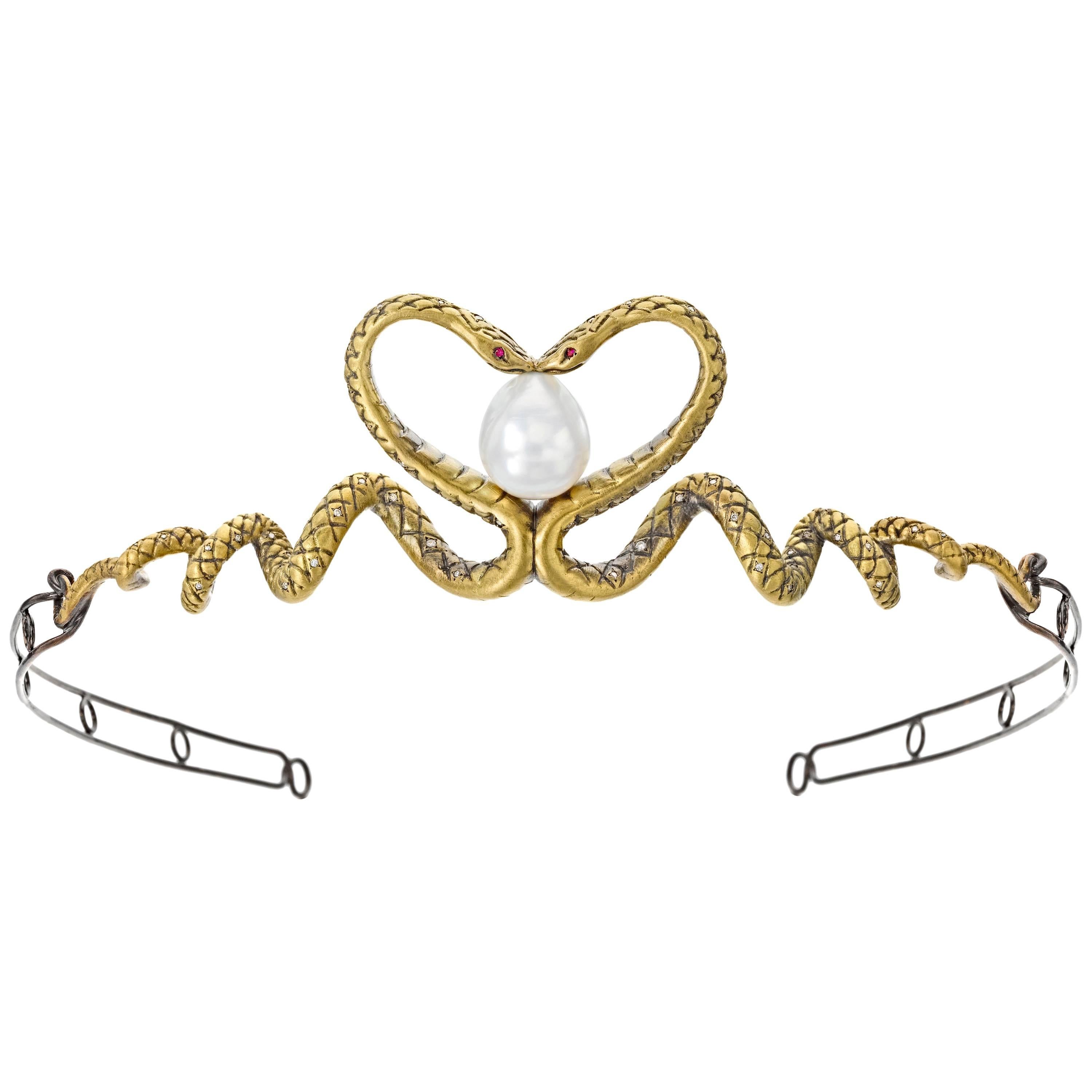 Two twisting 18K yellow gold and diamond snakes kiss in the center of this darkly romantic serpentine tiara, forming a heart that embraces a large, baroque South Sea pearl. In creating this piece, Wendy paid as much attention to function as to form: