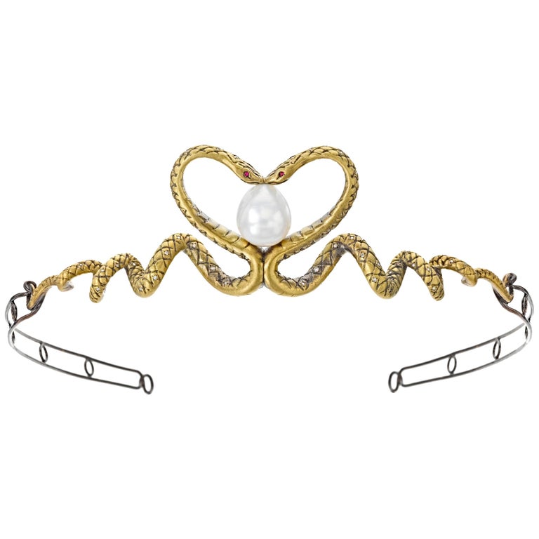 Two twisting 18K yellow gold and diamond snakes kiss in the center of this darkly romantic serpentine tiara, forming a heart that embraces a large, baroque South Sea pearl. In creating this piece, Wendy paid as much attention to function as to form: