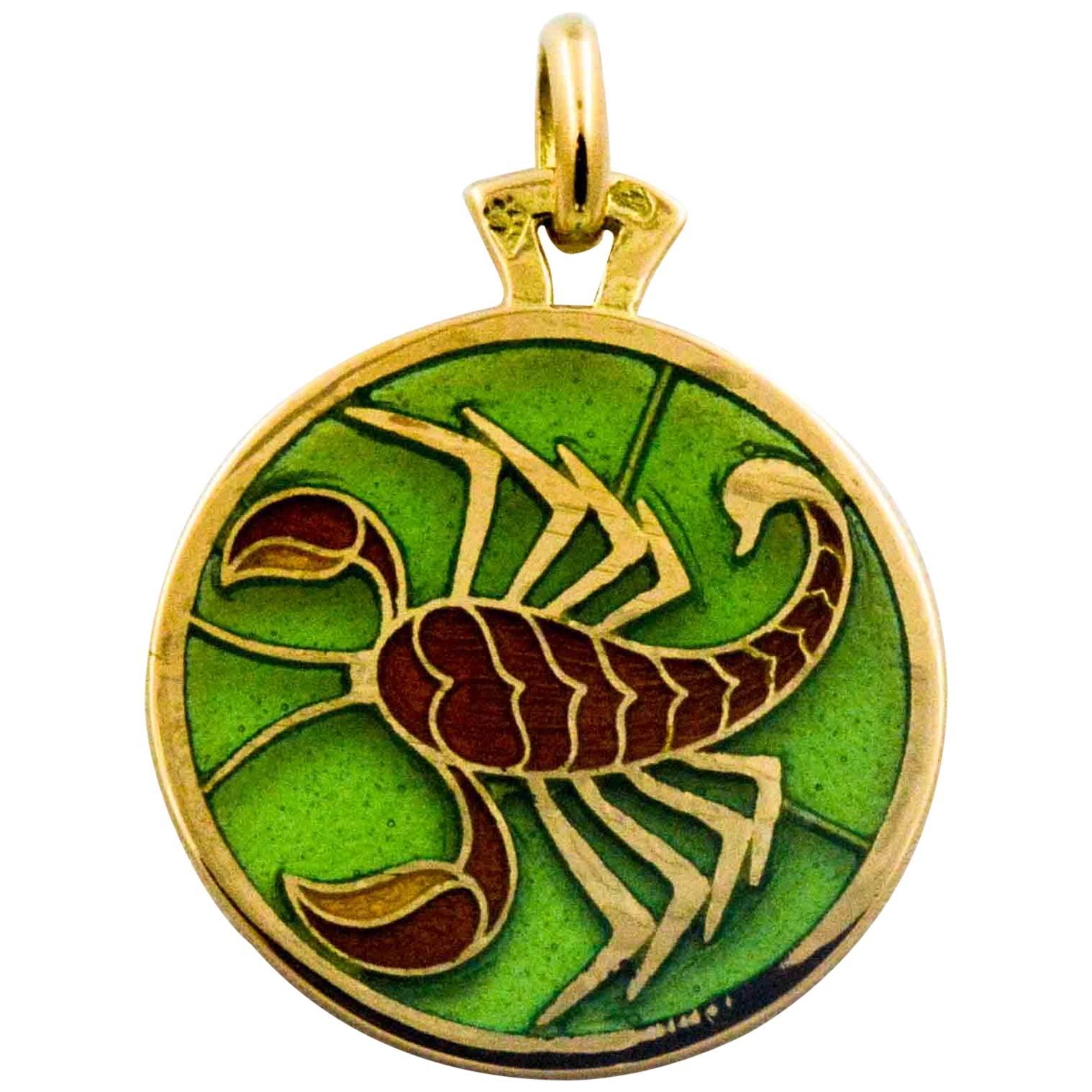 With a pale green stained glass background, this 18 karat yellow gold 19.65mm Scorpio pendant is lightweight  with intricate details handcrafted by a master Plique a Jour craftsman.  The beauty is in the details of this Scorpio hand enameled pendant.