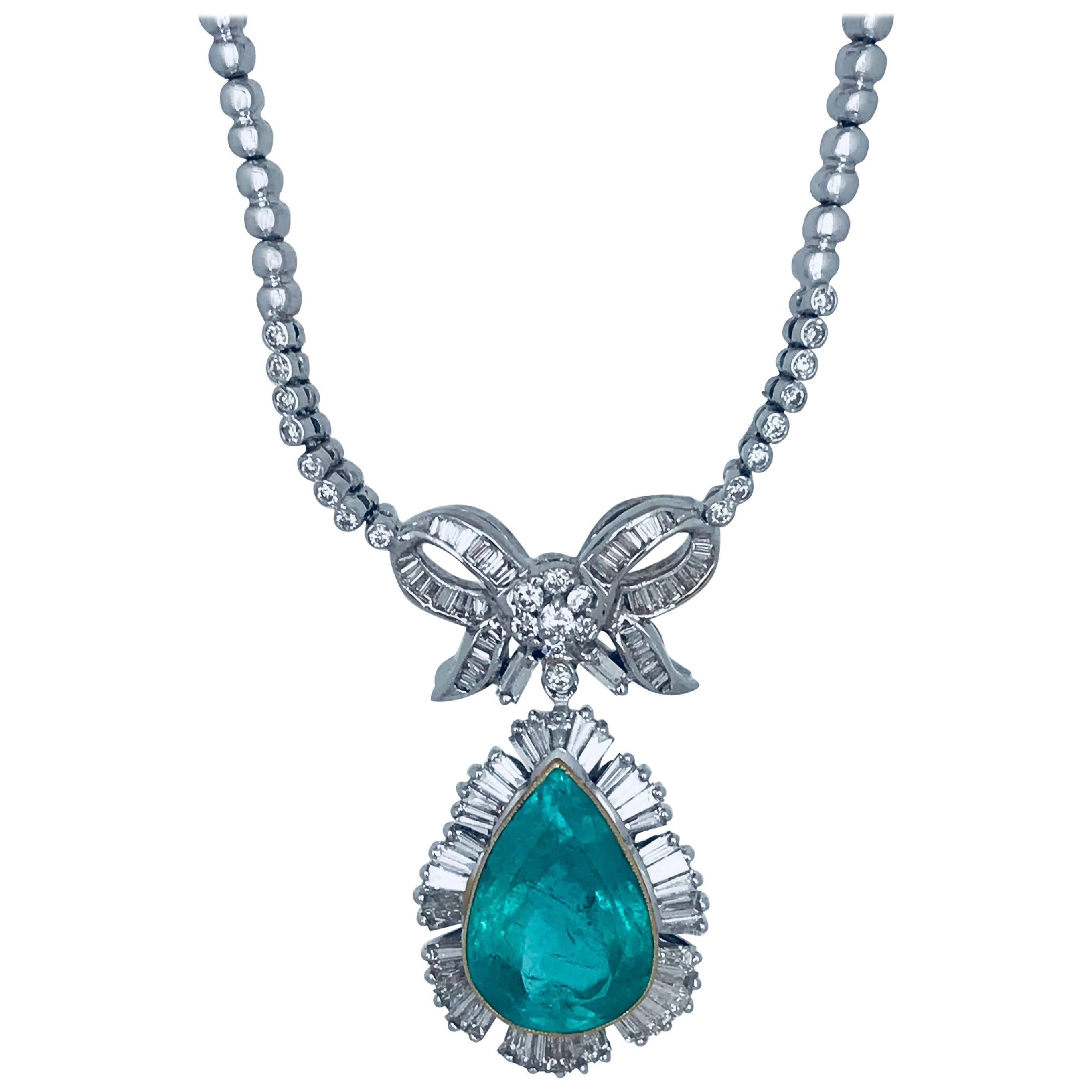 Colombian Emerald & Diamond Lavaliere Necklace. The Emerald is pear-shaped weighing approximately 15.36 carats. The diameter is 22.47-14.61 x 9.21 millimeters. 
Accenting the bezel-set emerald are (44) tapered baguette diamonds having a total weight