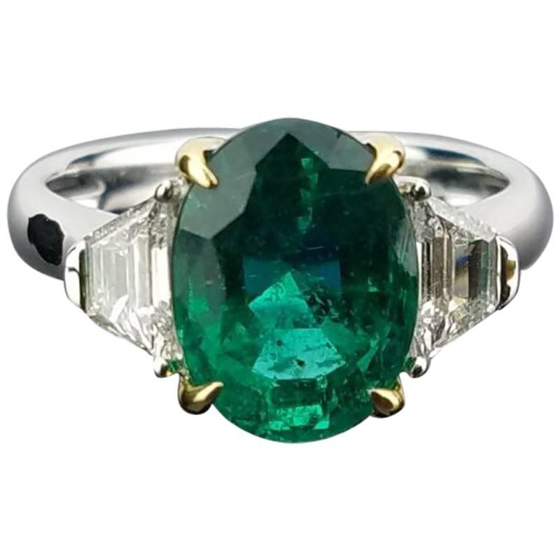 3.95 Carat Oval Emerald and Diamond Three-Stone Ring