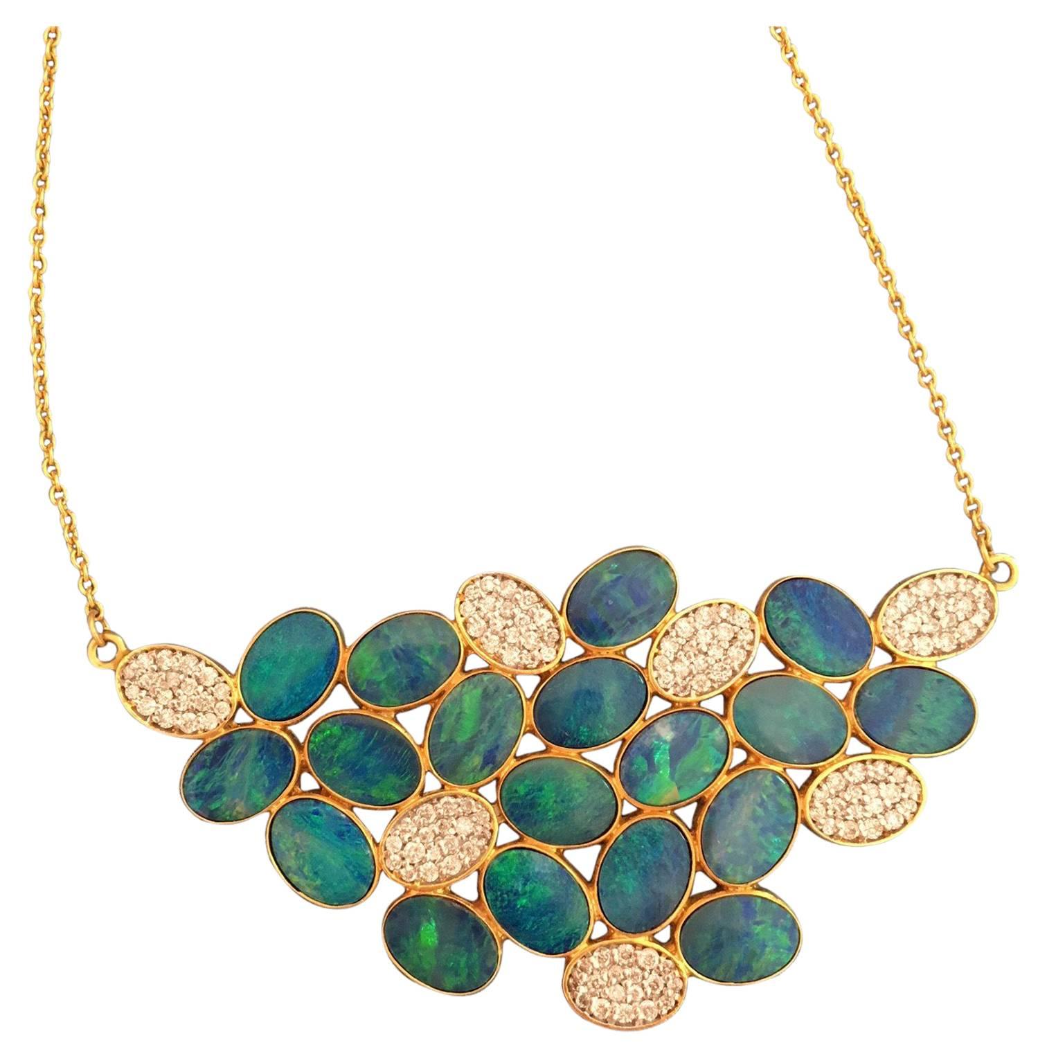 This boulder opal doublet and .68cts Diamond necklace is delicate yet bold.  Colorful flashes of blue and green catch the light in each distinct opal oval, and the diamond detail makes the piece feel elegant and artistic.  Finished in Lauren