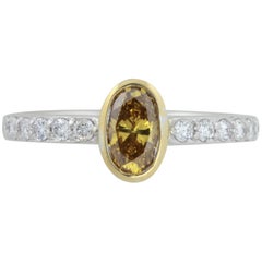 GIA Certified .56 ct Orange Yellow Oval Diamond In 18kt Two Tone Diamond Ring