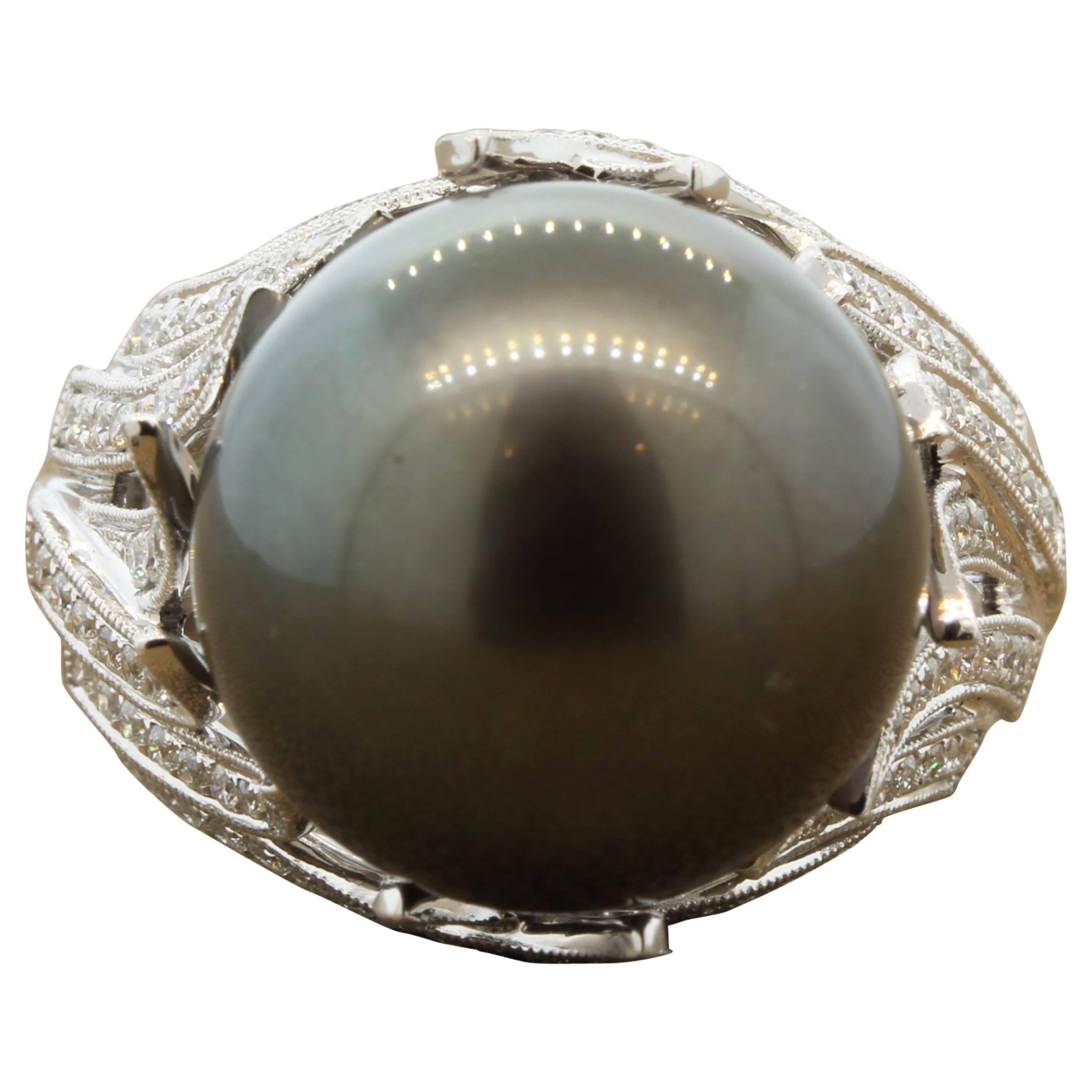 A contemporary gold ring featuring a 15.5mm Tahitian pearl, as large as the come. There are 0.66 carats of round cut diamonds set in 18K white gold. Every woman needs a classic pearl piece.
Size 7 

