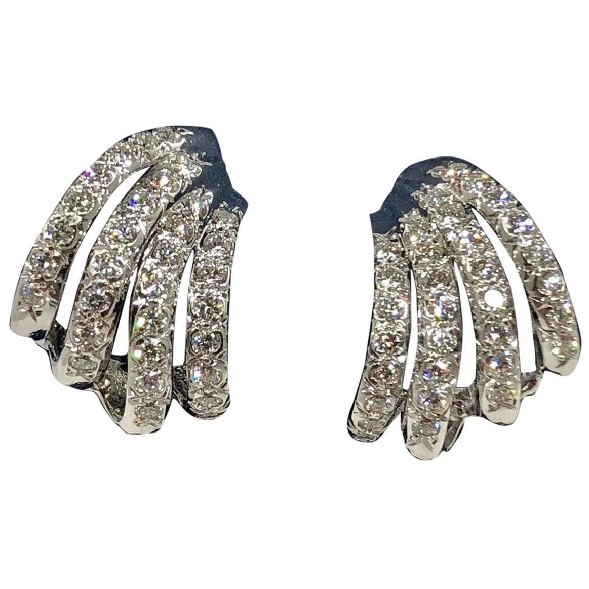 Henry Dankner and Sons 18 karat white gold and diamond climber earrings. Created by Henry Dankner & Sons, this stunning pair of earrings are designed with 64- full cut round diamonds equaling 1.50 carat approximate total weight, average color G-H,