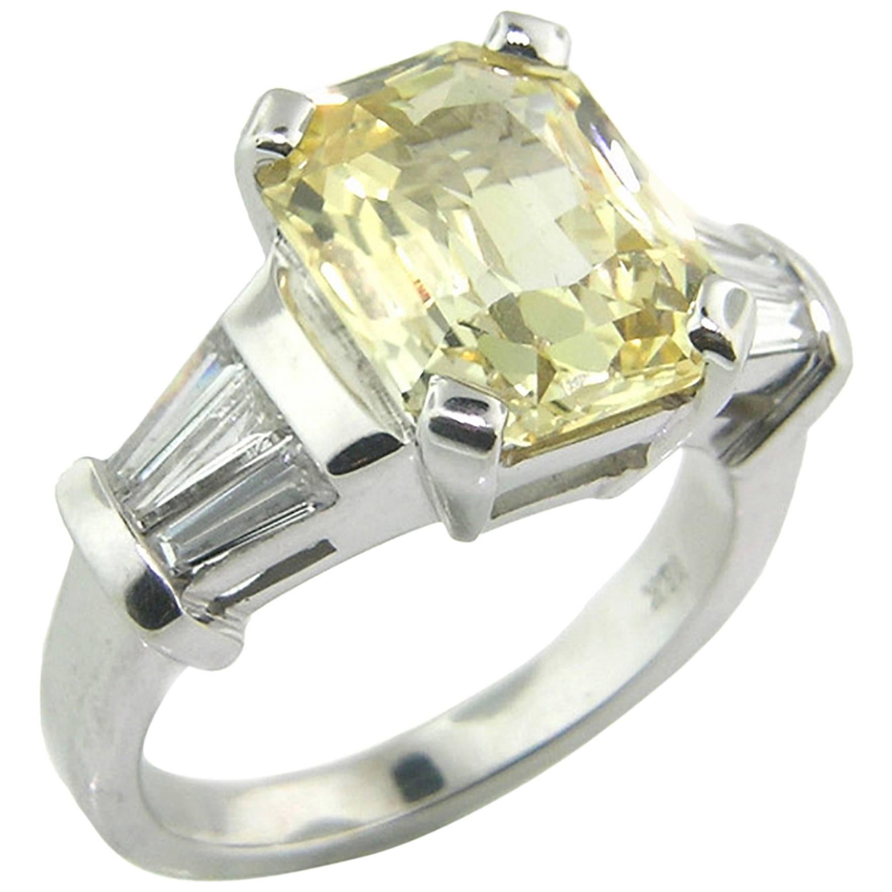 This natural color 5.44ct yellow sapphire from Sri Lanka (Ceylon) is precision faceted in a gorgeous radiant emerald cut.  This stone sparkles like crazy, and the luxurious size and soft canary color will command attention. 

The diamonds have a
