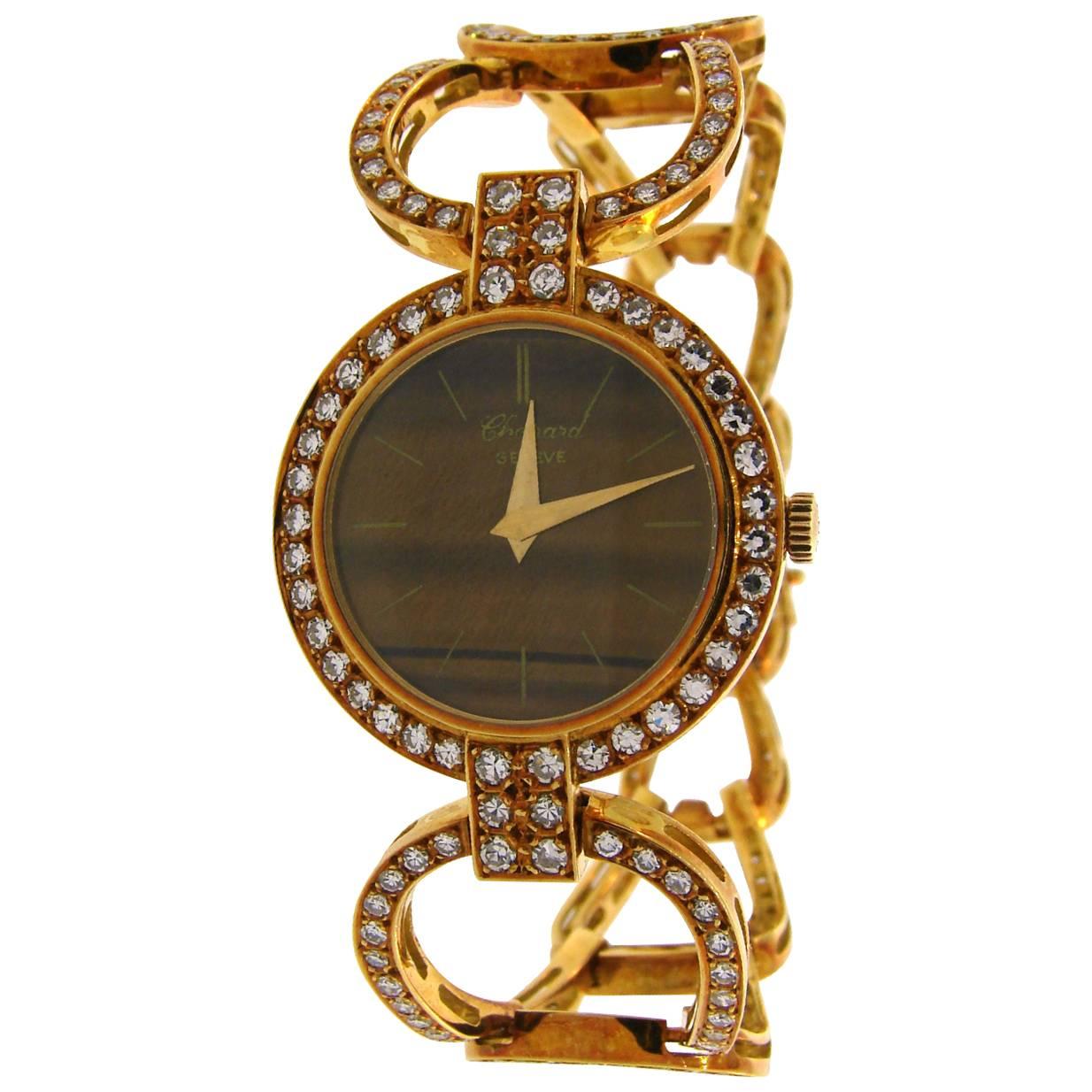 Beautiful feminine watch created by Chopard in the 1970s. Tasteful combination of earthy colored Tiger's Eye and yellow gold with splashes of sparkly diamonds, perfect proportions and light openwork design are the highlights of this lovely vintage