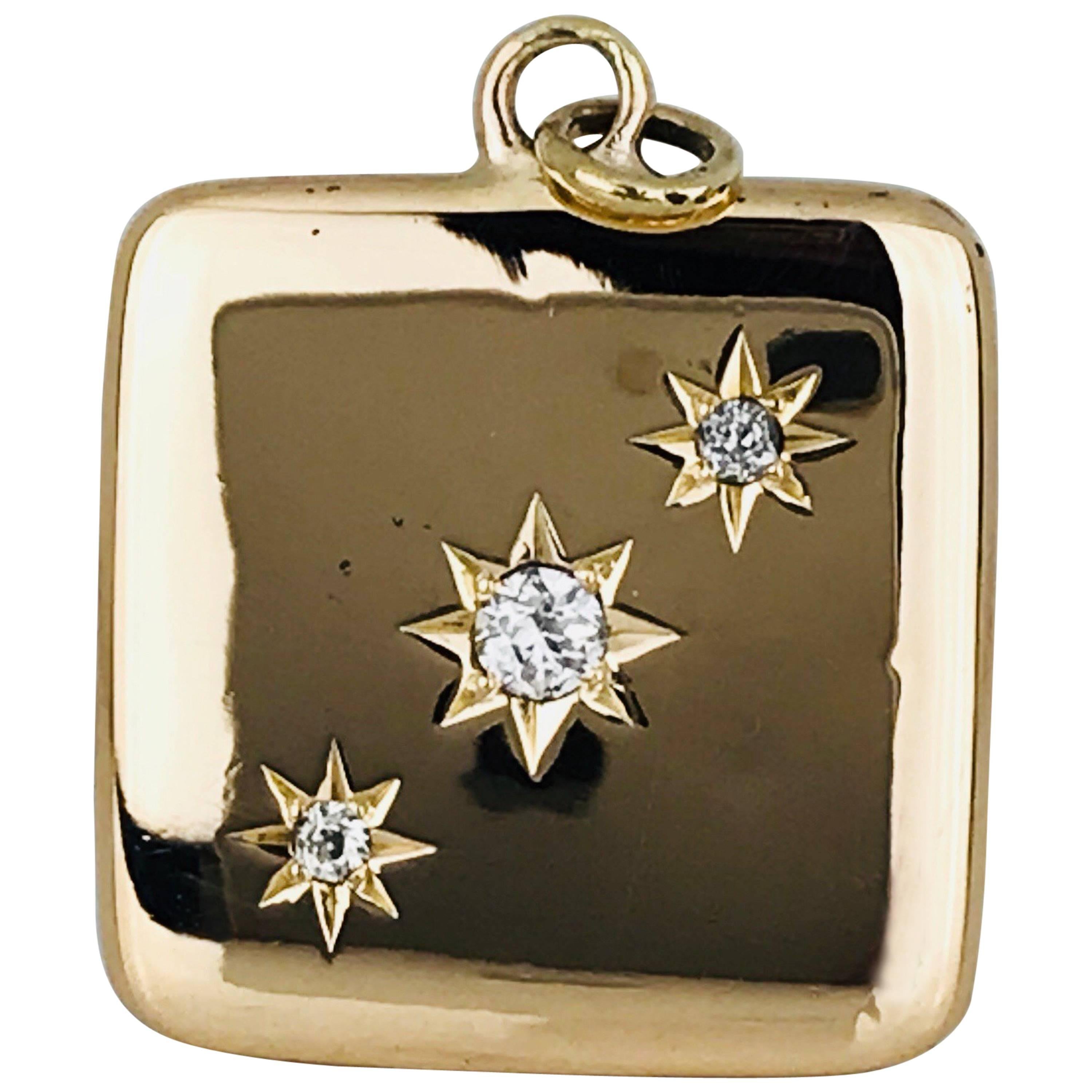 Highly polished, 14 karat yellow gold, square photo locket opens from the top and features 3 round brilliant, bead-set diamonds European-cut in a diagonal line.
Edwardian Circa 1900's

Diamonds measure 3.4 and 2.4 millimeters, with a quality of SI1