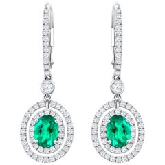 1.01 Carats Total Oval Cut Emerald and Diamond Halo Dangle Earrings