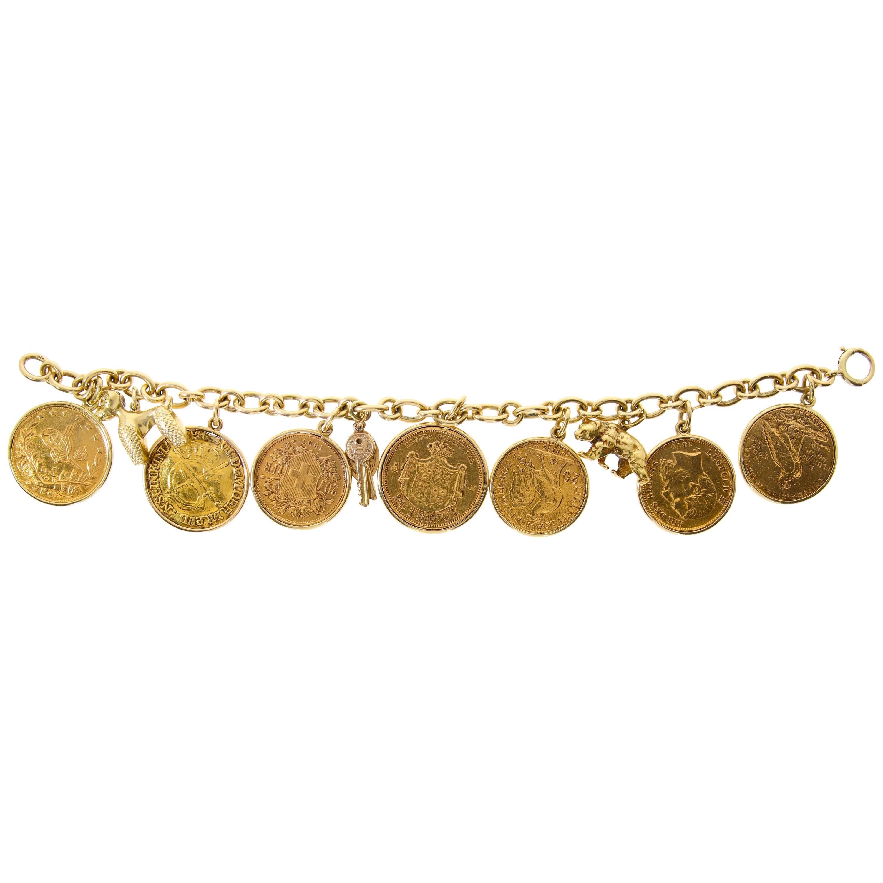 Yellow Gold Coins and Charmes Bracelet, circa 1950 For Sale