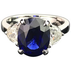 Certified 5.06 Carat Vivid Blue Sapphire and Diamond Three-Stone Ring