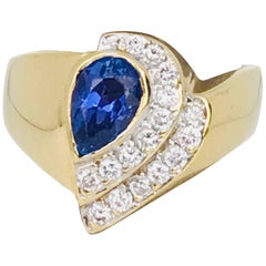 Pear Deep Blue Colored Tanzanite, Art Nouveau Style Ring with Pave Set Diamonds