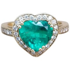 1.68 Carat Heart Shape Emerald Set in 18 Karat Yellow Gold with Diamond Halo