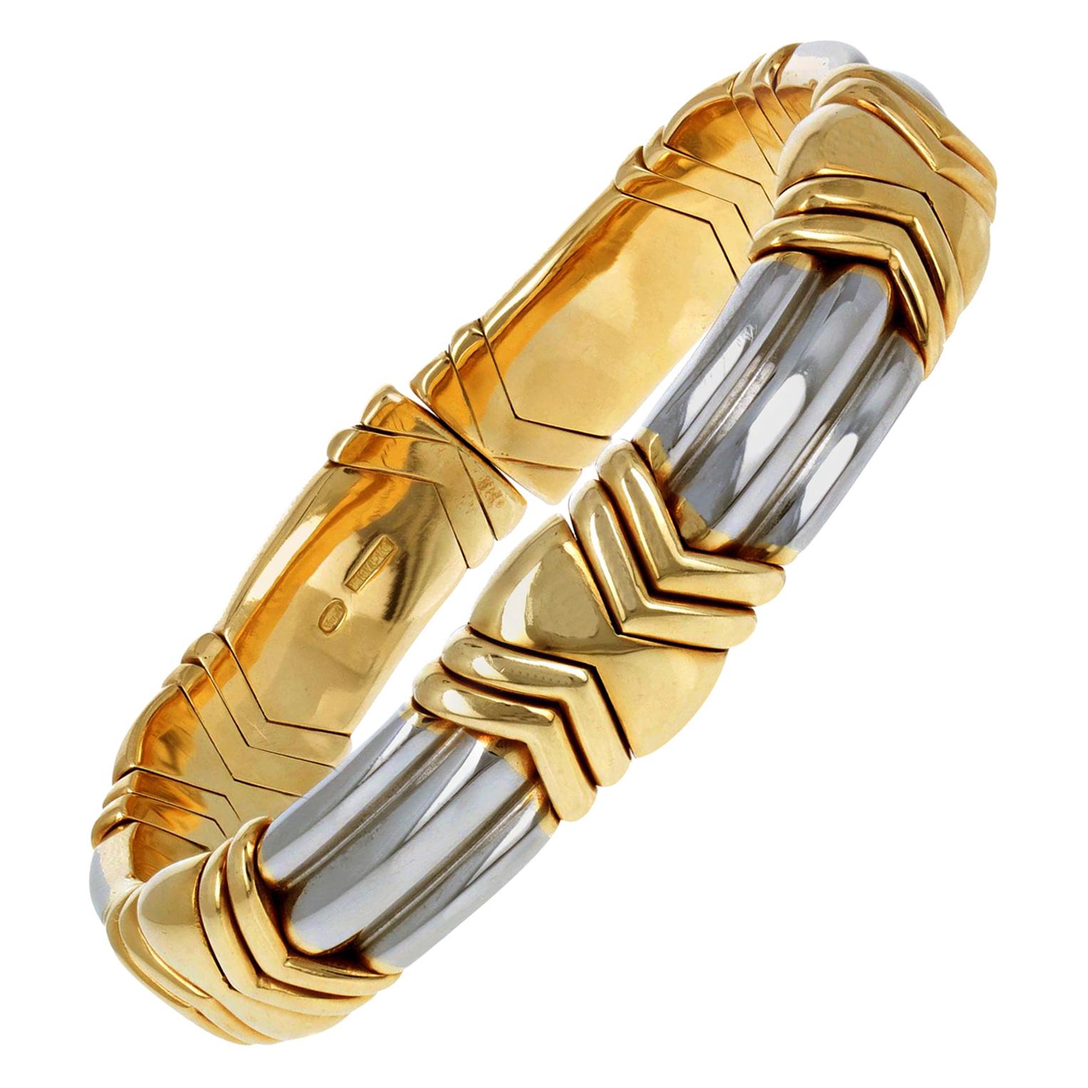 A bracelet of interlocking elements, mounted in steel and 18k yellow gold, signed ‘Bulgari’, circa 1990. Flexible for opening the gap and slipping in your wrist. 

* Signed 'BVLGARI' 
* Italian hallmark with star, maker's registration number and