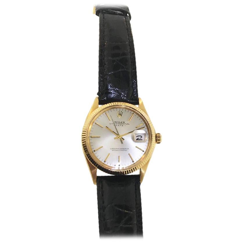 Vintage 1967 Rolex Oyster Perpetual Date wristwatch. Date and second hand. Automatic movement. On strap. Fluted Bezel. Recently overhauled and in great running condition.  Rare silver/ivory dial with gold batons.  With vintage Rolex box.   A super