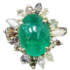 Natural White, Yellow and Brown Diamonds Surrounding a Emerald