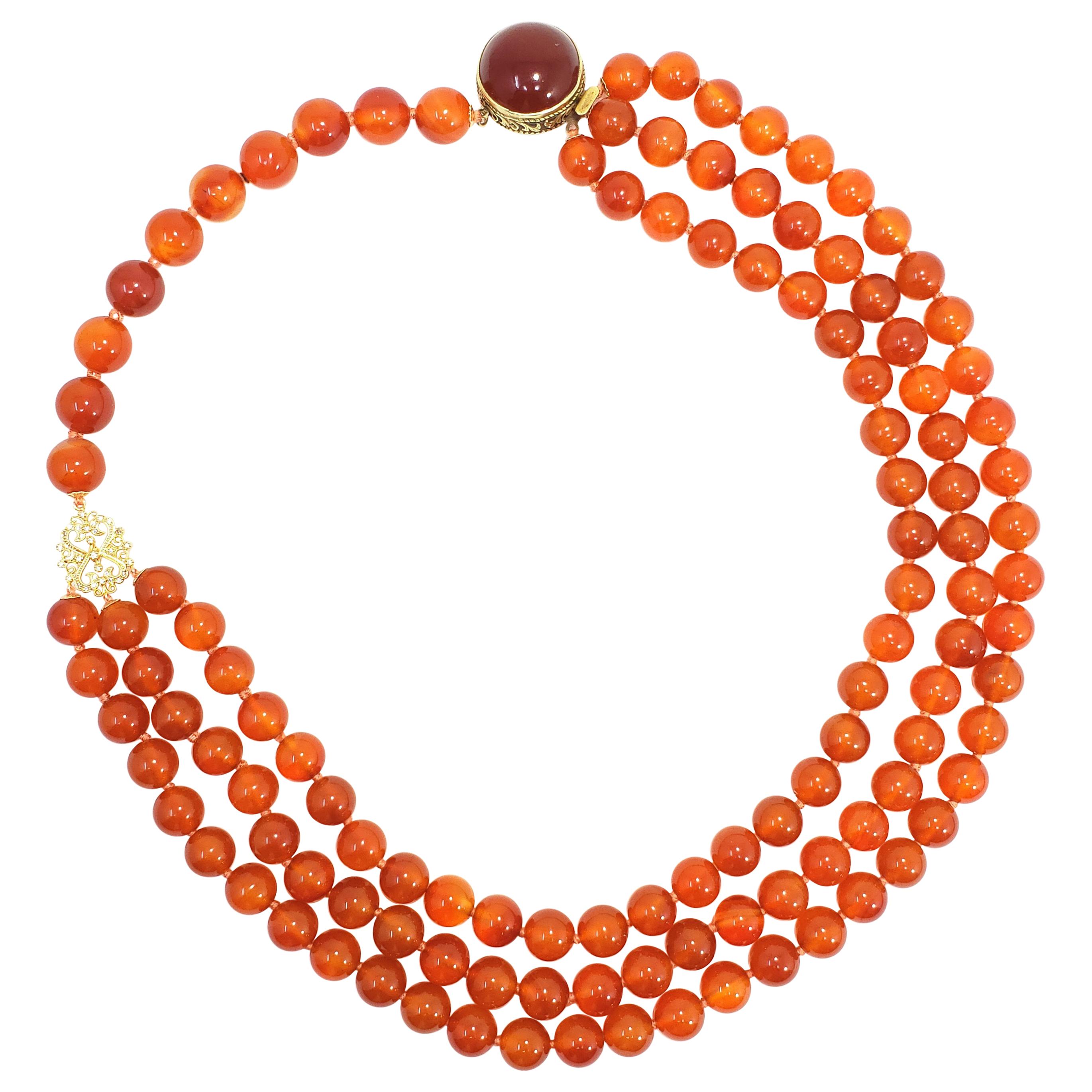 Carnelian Bead Knotted String Triple Strand Necklace, 14 Karat Clasp For Sale