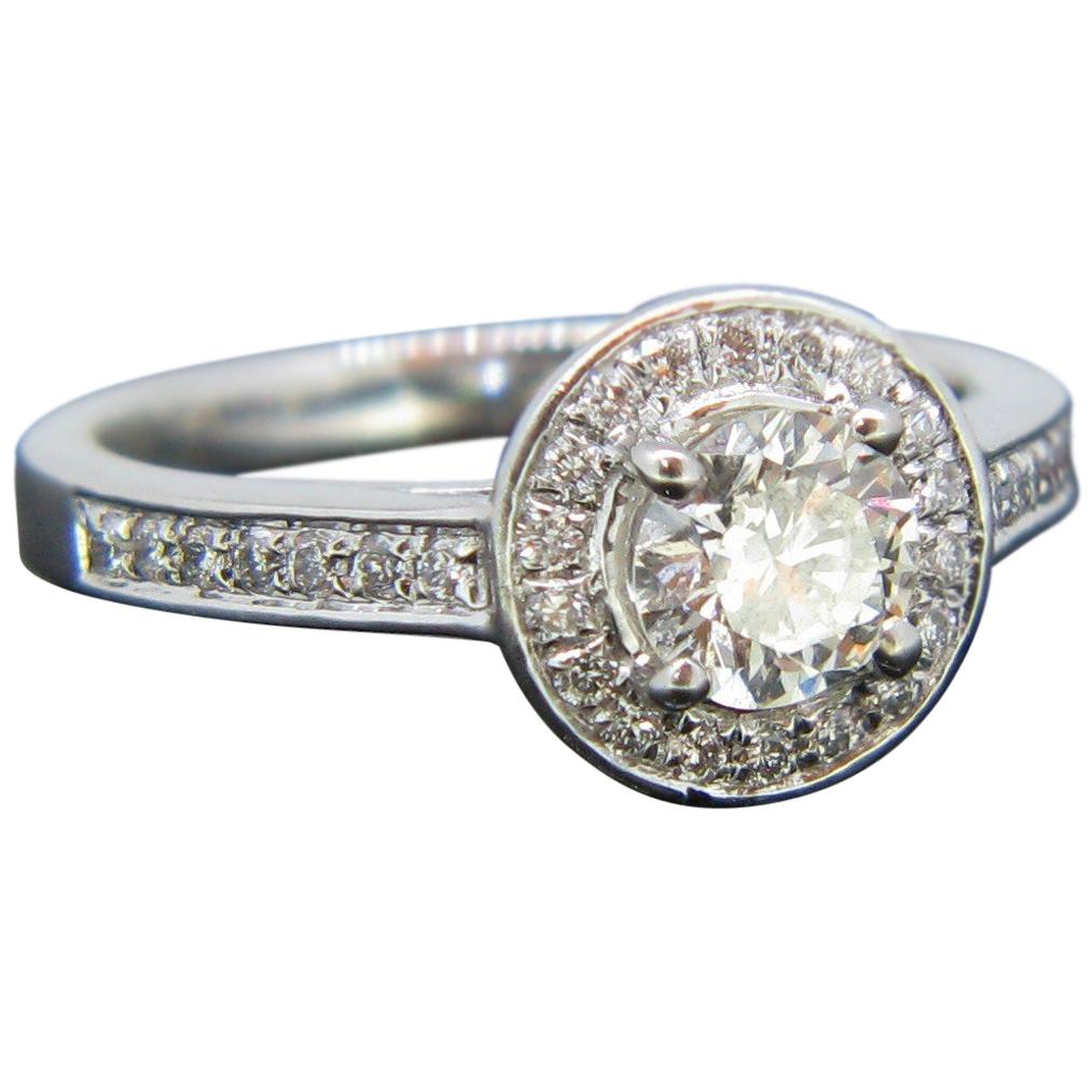 Modern 0.63 Carat Diamond Halo Cluster Platinum Engagement Ring For Sale