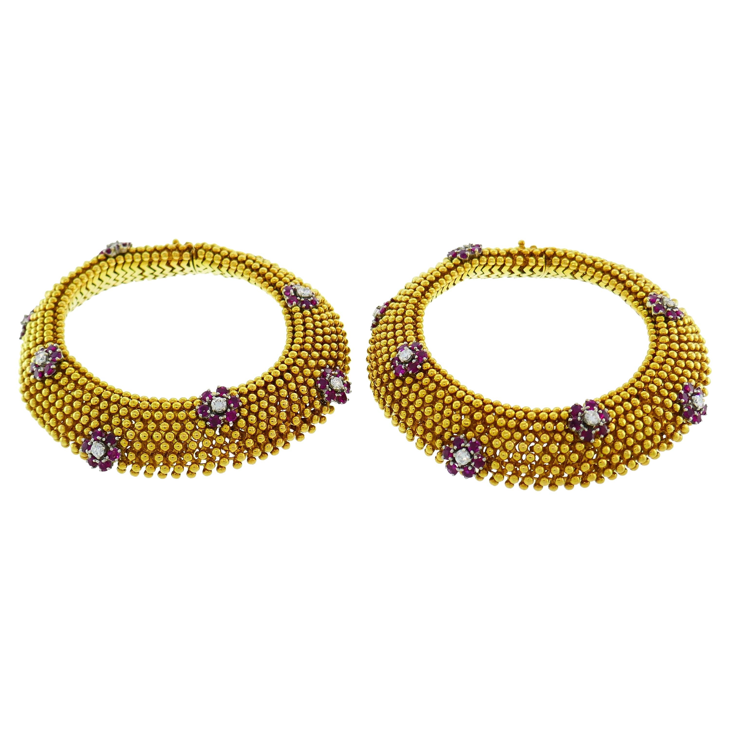 Classy and feminine pair of bracelets created in the 1970's. Tasteful color combination of yellow gold and red ruby with sparkly diamonds, volume, outstanding workmanship make the bracelet  elegant, stylish and very chic. The pair is a great