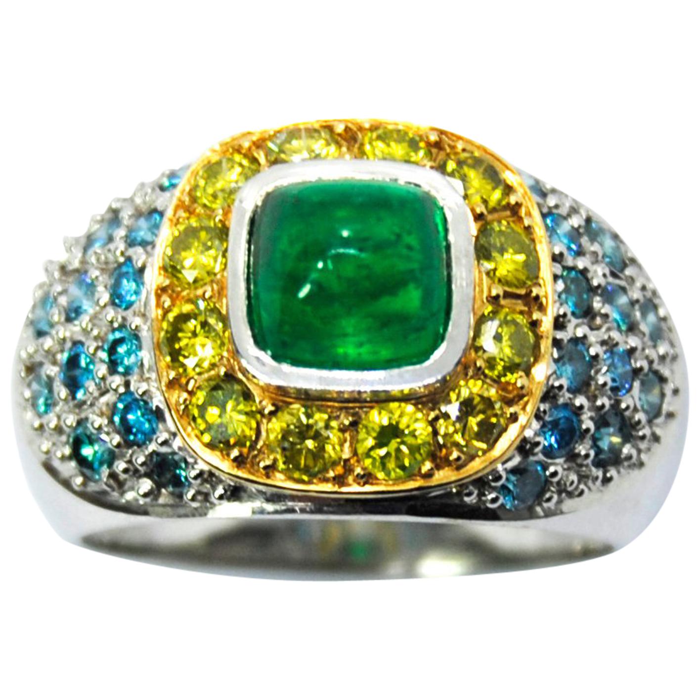 Cabouchon Emerald in a Tray of Blue and Yellow Diamonds in a 18 Karat White Ring