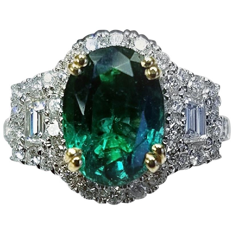 18 Karat White Gold Oval Cut Emerald and Diamond Ring