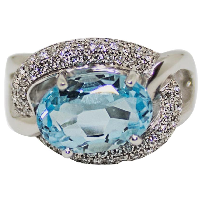 1 Carat Blue Topaz with Diamond Halo Set in an 18 Karat Gold Engagement Ring For Sale