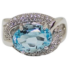 1 Carat Blue Topaz with Diamond Halo Set in an 18 Karat Gold Engagement Ring