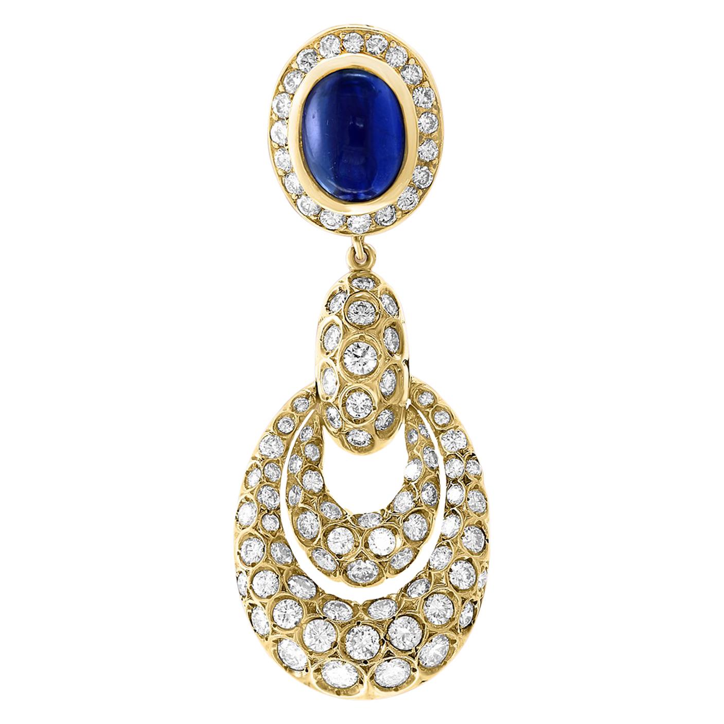 15 Carat blue Sapphire  Cabochon and Diamond Hanging/Cocktail Earring 18 Karat White Gold.
 perfect pair made in  18 carat Yellow gold . 
18 K gold 33 Grams
 Diamonds: approximate 6.5 carat , VS Quality G color
Its very hard to capture the true