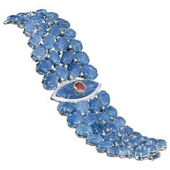 Set in 18K gold, carved Burma Blue Sapphire, Ruby and diamonds flexible bracelet