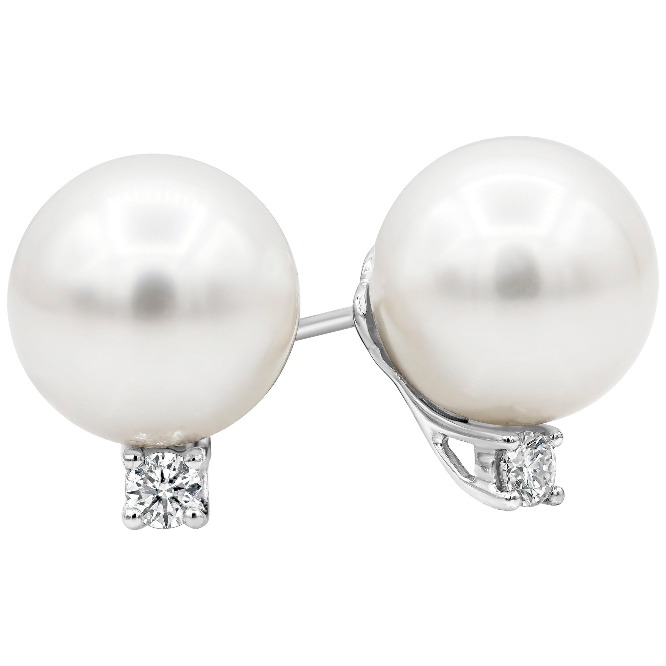 A classic and unique style pearl stud earrings showcasing a 12 mm white pearl accented with a single round brilliant diamond weighing 0.16 carats total, set in a classic four prong setting. Finely made in 18K White Gold.

Style available in