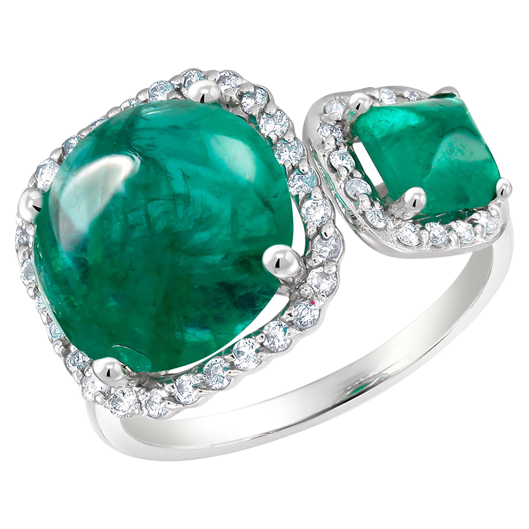 Eighteen karats white gold open shank cocktail ring 
Two Cabochon emeralds in halo setting
Round shape cabochon emerald weighing 6.36 carat  
Sugarloaf cabochon emerald  weighing 0.85 carat
Diamond weighing 0.70 carat                                